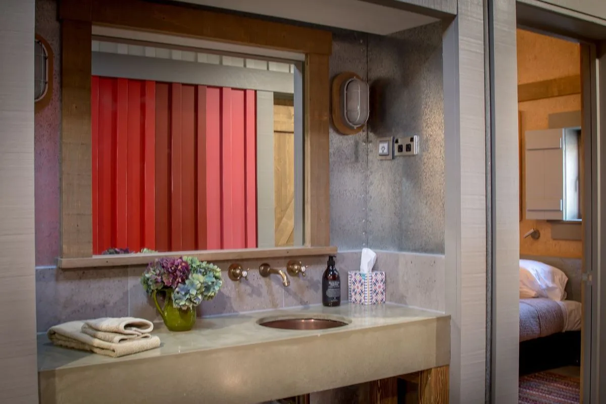 Finished Camp Glenorchy bathroom with concrete basin and brass fittings
