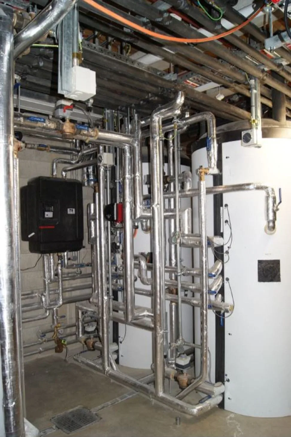 Camp Glenorchy plant room with coordinated pipework and hot water storage