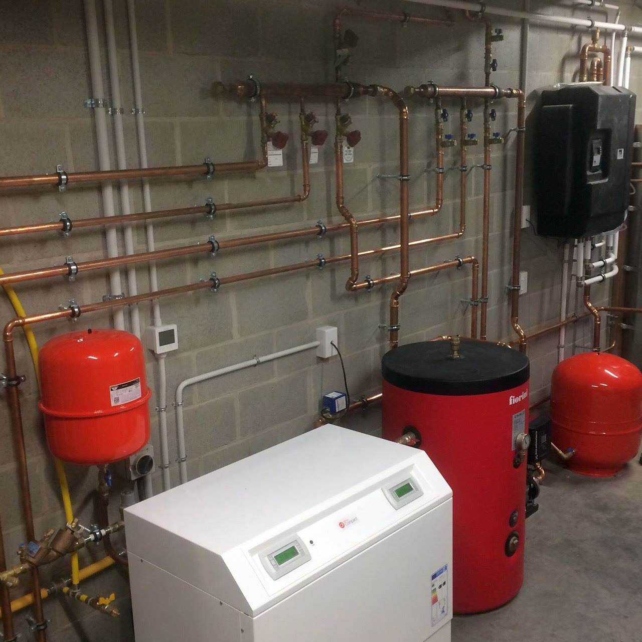 Hydronic heating plant room with pumps, controls and pipework