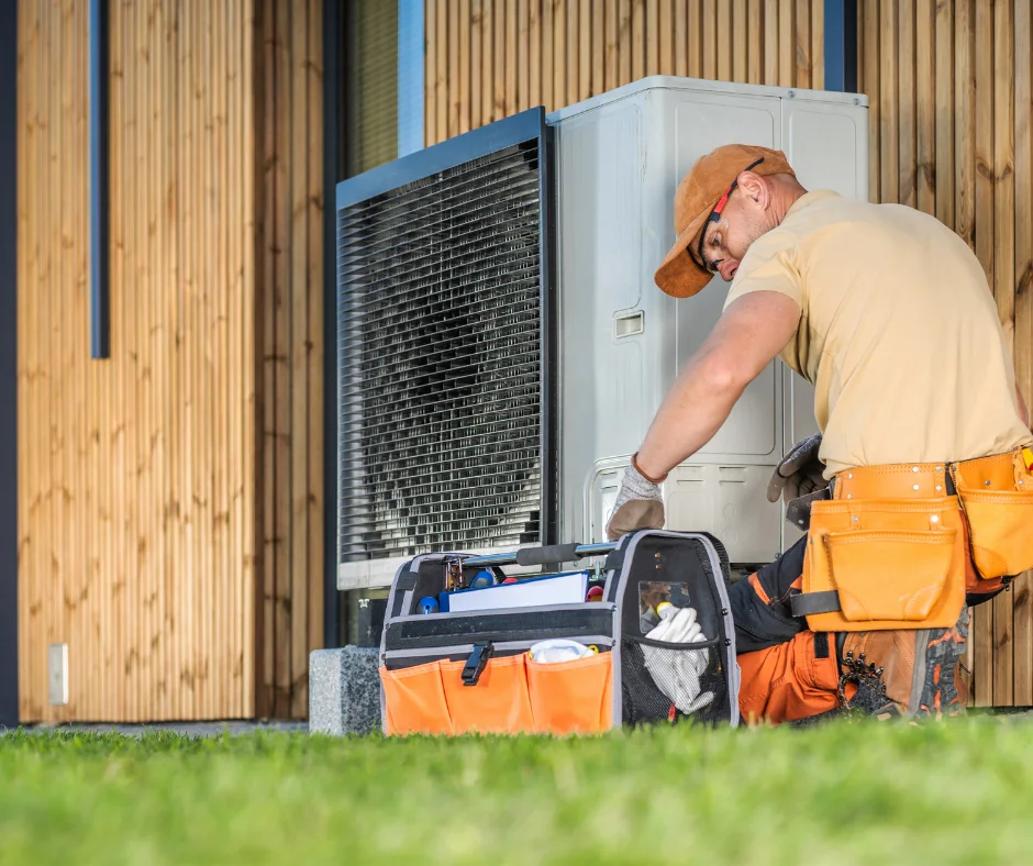 Technician servicing an outdoor heat-pump unit