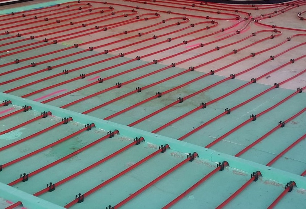 Hydronic underfloor heating pipework laid across an insulated floor before the slab is poured